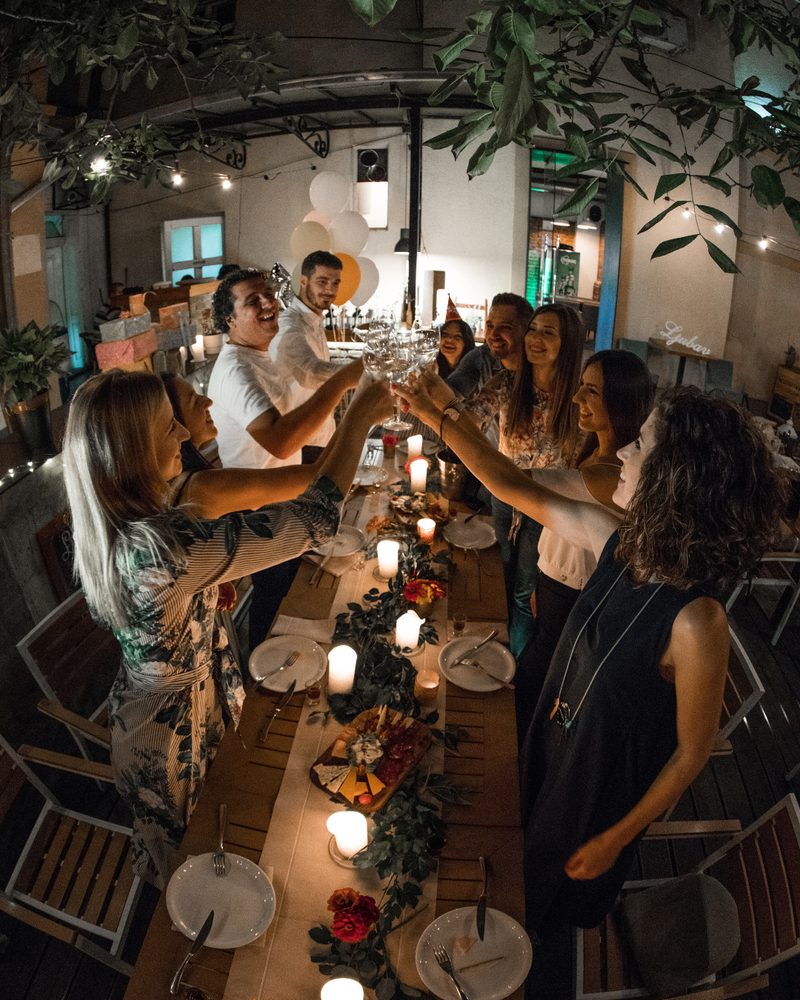 Guests raising a toast around a candlelit table at a private celebration